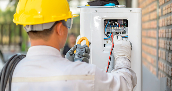 air conditioner technician is checking air compressor system