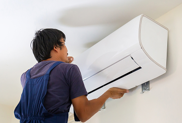 electrician installing air conditioner unit