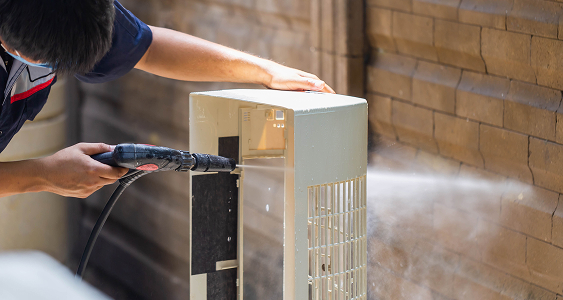 repairman washing dirty comparments air conditioner