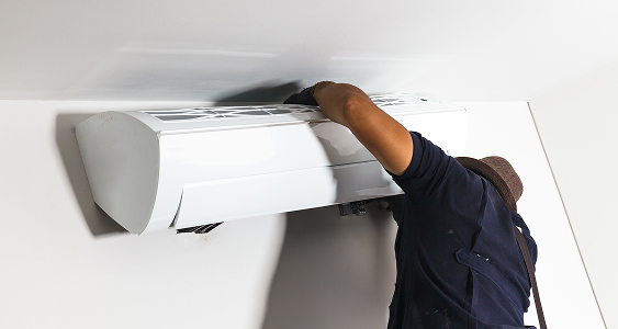 technician air conditioning installs new air conditioner